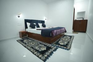 a bedroom with a bed and a rug at Parkview Hotel in Khajurāho