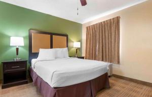 a large bed in a hotel room with two lamps at Studio 6 Extended Stay Florence KY - Meijer Dr Cincinnati in Florence +18 photos