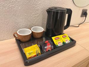 Příslušenství pro přípravu čaje a kávy v ubytování Tamashii Boutique Hotel