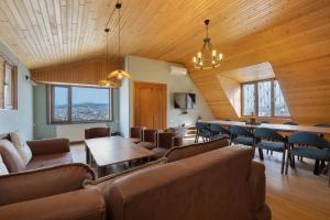 a living room with couches and a table and chairs at Apartments with wine cellar in Old Tbilisi in Tbilisi City