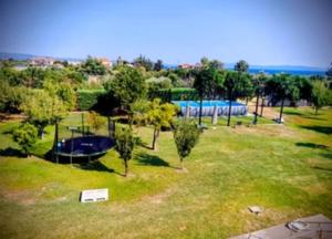 an aerial view of a park with trees and a pool at Green Galini Villa Pelion in Káto Lekhónia