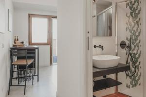 a bathroom with a sink and a counter with a table at Dimora le Due Sicilie in Cefalù +62 photos