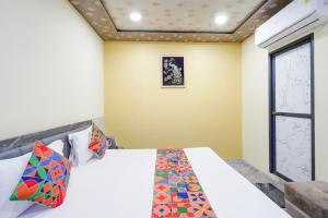 a bedroom with a bed and a window at FabHotel Shivkashi Inn - Dasaswamedh Ghat in Varanasi +21 photos