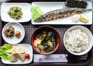 a tray of food with a fish and rice at Sakura Hotel 3 in Hanoi