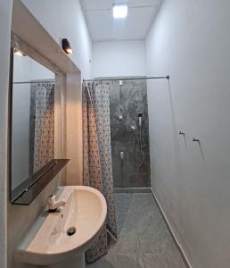 a bathroom with a sink and a shower at The Glown Weligama in Weligama