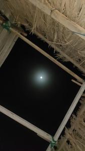 a room with a ceiling with a light in it at Home of turtles in Al Ḩadd