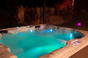 a jacuzzi tub in a backyard at night at Love Room Fire Sens in Breurey-lès-Faverney