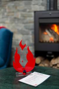 a red item on a table in front of a fireplace at Love Room Fire Sens in Breurey-lès-Faverney +3 photos