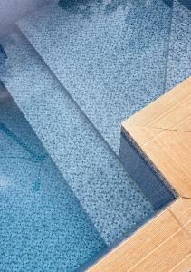 a blue tile floor in a room with a table at Canto da Manu Panoramic in Calheta