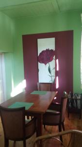 a dining room with a wooden table and chairs at Bülitz33 in Niederdorla +9 photos