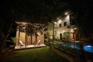 a house with a swimming pool at night at Canaya Boutique Villa in Galle