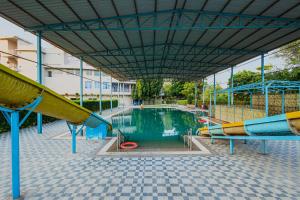 a pool of water with a slide and a slide at Bamboo Saa Sunrrise Wedding & Wellness Resort, Jaipur in Jaipur