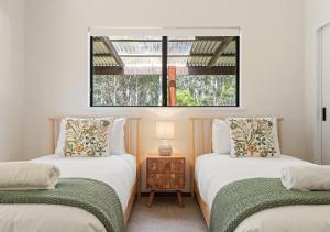 Voodi või voodid majutusasutuse Whisperwood toas