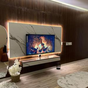 a living room with a flat screen tv on a wall at Samara in Riyadh