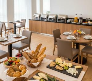 a group of tables with bread and pastries on them at Doksanlar Apart  +16 photos