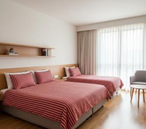 a hotel room with two beds and a window at Doksanlar Apart 
