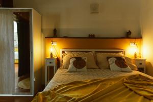 a bedroom with a large bed with two pillows at Casa di Lucy Spello - Cave Wellness & Panoramic View in Spello
