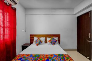 Ένα ή περισσότερα κρεβάτια σε δωμάτιο στο FabHotel Pavis Inn