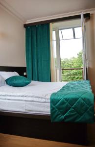 a bedroom with a bed with a large window at Green Hills Resort in Hankʼavan