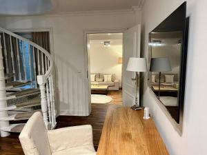 een woonkamer met een witte bank en een spiegel bij Hygge Suite Sylt Kampen in Niederdorla +25 foto's