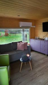 a living room with a couch and a table at NOCLEGI AGRO-RELAX in Kozielice