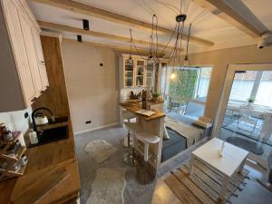 a room with a bed and a kitchen with a table at Lake House by Fregata Restaurant in Zagórze Śląskie +26 photos