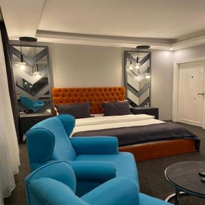 a bedroom with a bed and a blue chair at Valeron Suit Premium in Istanbul