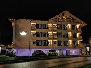 a building with cars parked in front of it at night at Hotel Nassereinerhof in Sankt Anton am Arlberg