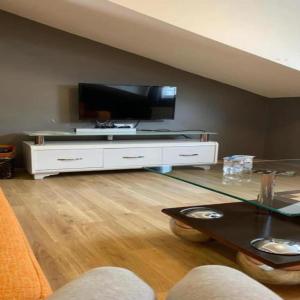 a living room with a flat screen tv and a table at Valeron Suit Premium in Istanbul +29 photos