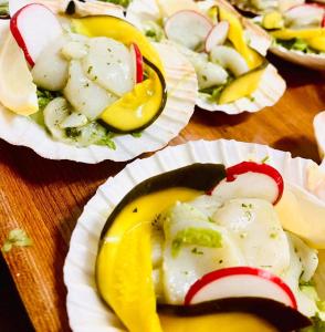 ein Holztisch, bedeckt mit Papptellern mit Essen in der Unterkunft Hébergement Centre Missionnaire Saint Jacques in Guiclan