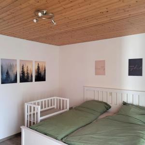 a bedroom with two beds and a wooden ceiling at Familiennest-Eifel in Blankenheim +19 photos