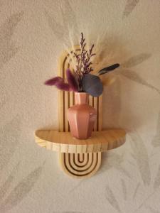 a vase on a shelf with a plant in it at Familiennest-Eifel in Blankenheim