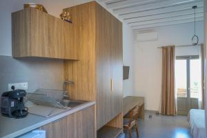 a kitchen with a sink and a desk in a room at Remezzo in Koutalás