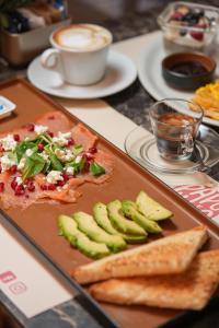 a table with a cutting board with a plate of food at Corso Boutique Luxury Rooms in Rome +42 photos