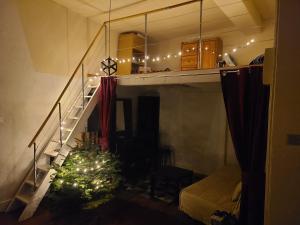 a living room with a christmas tree on the stairs at Le nid de la ferme du plan in Froges
