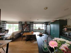 a kitchen and living room with a table and chairs at Stay With Jack in Limerick