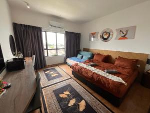 a bedroom with a bed and a couch in a room at AnR Studio Suite Inside H Elite Building in Kota Bharu