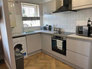 a kitchen with a washing machine and a washer at 1 Anderson Court in Stornoway