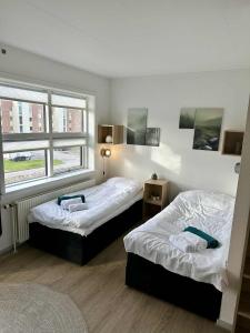 a bedroom with two beds and a window at Villashea in Skanderborg