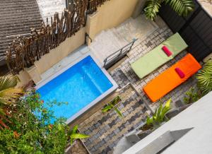 an overhead view of a swimming pool with two chairs at Old Chilli House in Unawatuna