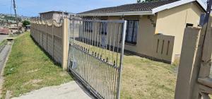 a fence in front of a house at Ingeyethu Guest House in Umlazi +2 photos