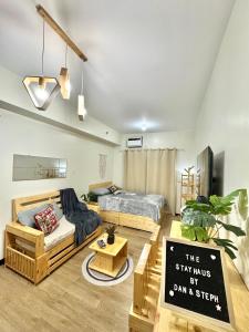 a living room with a bed and a sign in it at The Stayhaus by Dan & Steph in Manila +36 photos