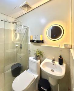 a bathroom with a toilet and a sink and a shower at The Stayhaus by Dan & Steph in Manila