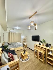 a living room with a bed and a tv at The Stayhaus by Dan & Steph in Manila