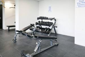 a gym chair with weights in a room at Bright 1BR with Balcony the Gate, Masdar City in Abu Dhabi