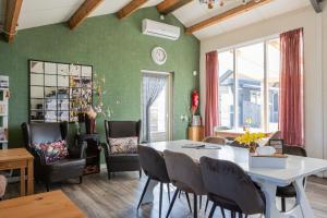 a dining room with a table and chairs at Gelders genieten in Overasselt