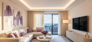 een woonkamer met een bank en een groot raam bij Lilac Apart 1 Antalya in Antalya