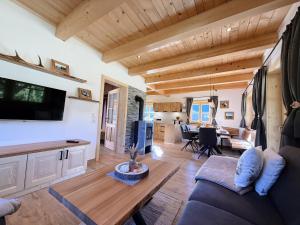 a living room with a couch and a table at Ferienhaus Bergmann in Bad Aussee