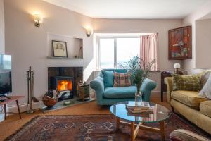 a living room with a couch and a fireplace at Greengates Nature Filled Countryside Escape 