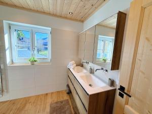 a bathroom with a sink and a mirror at Ferienhaus Bergmann in Bad Aussee +16 photos